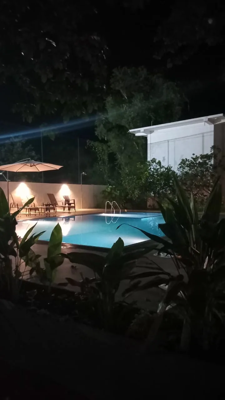 Swimming pool and outdoor seating at night in Udawalawe accommodation