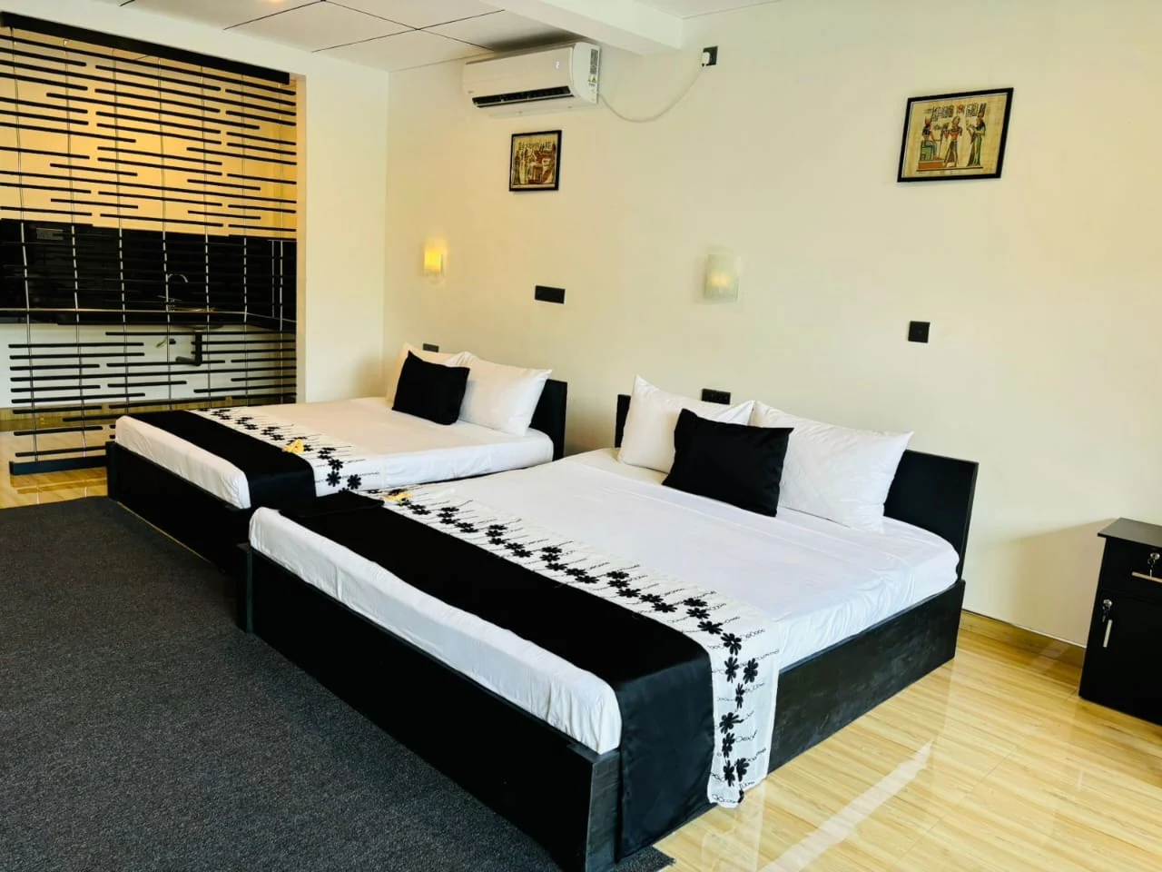 Family and triple room with two beds and attached wash area in Udawalawe